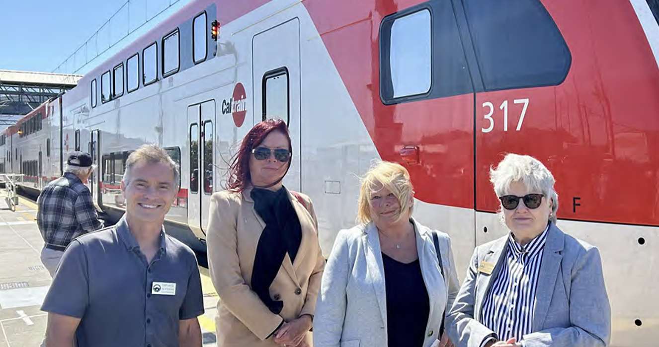 a group of older adults standing outside of a CalTrains car.